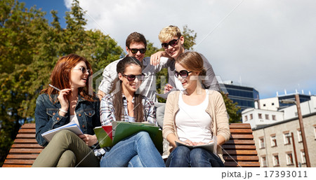 group of happy students with notebooks at campus 17393011