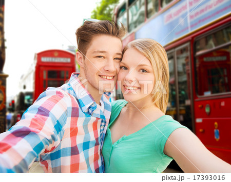 happy couple taking selfie over london city 17393016