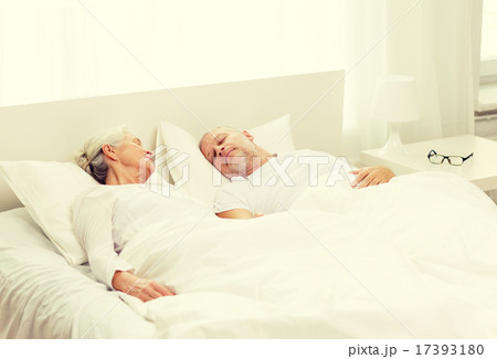 happy senior coupler lying in bad at home happy senior coupler lying in bad at home 17393180