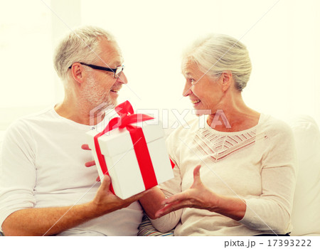 happy senior couple with gift box at home 17393222