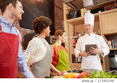 happy friends with tablet pc in kitchen happy friends with tablet pc in kitchen 17393246