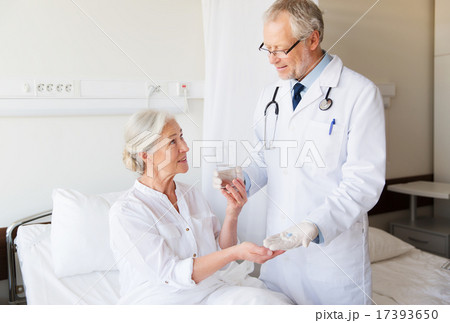 doctor giving medicine to senior woman at hospital doctor giving medicine to senior woman at hospital 17393650