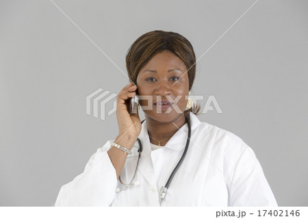 Black female doctor talking on telephone Black female doctor talking on telephone 17402146