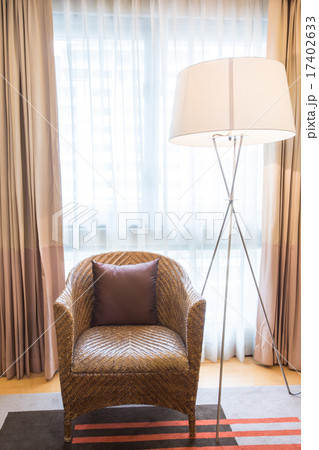 Light shines through white curtains in room 17402633