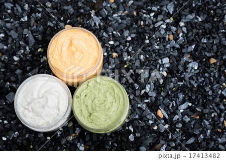 Group of cream on dark blue pebbles background 17413482