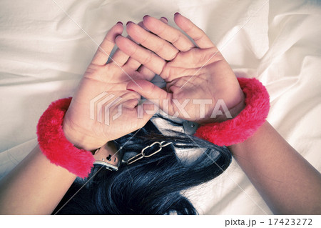 young woman in bed with sexy fluffy handcuffs young woman in bed with sexy fluffy handcuffs 17423272