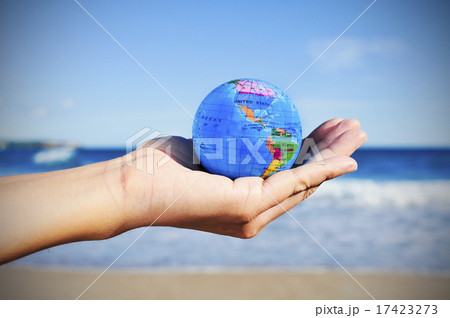 young man with a world globe in his hand 17423273