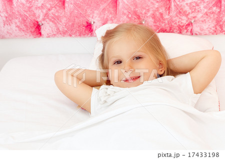 Adorable little girl resting in the bed closeup 17433198