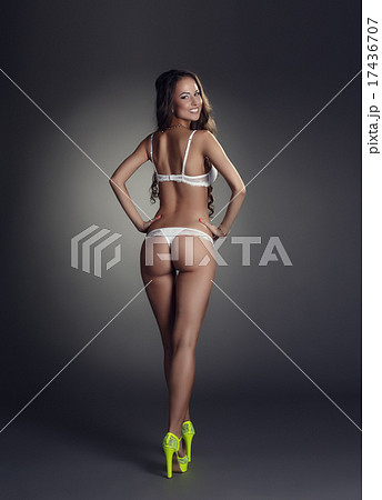 Rear view of smiling tanned model in underwear  17436707