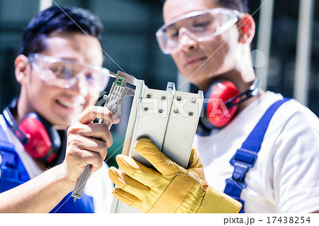 worker checking work piece in production plant 17438254