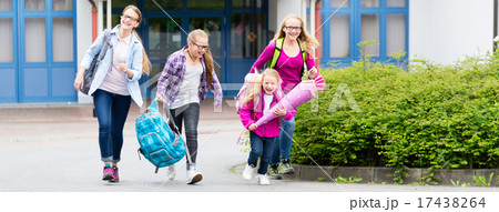 Group of students standing in front of school 17438264