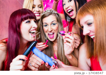 Women having bachelorette party with sex toys in night club 17438547