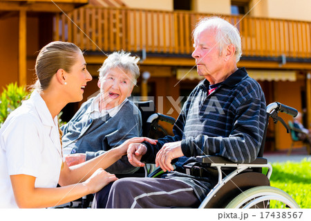 Seniors eating candy in garden of nursing home 17438567