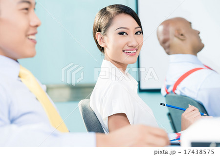 Chinese Businesswoman in meeting looking at camera 17438575