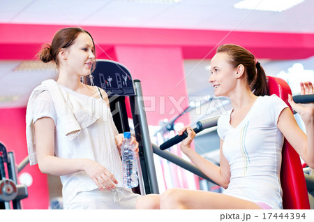 Woman doing splits on machine with weights 17444394