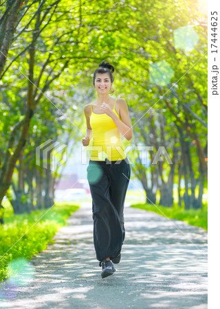 Runner - woman running outdoors in green park Runner - woman running outdoors in green park 17444625