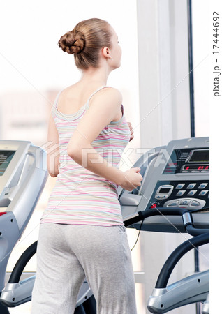 Woman at gym exercising. Run on machine 17444692