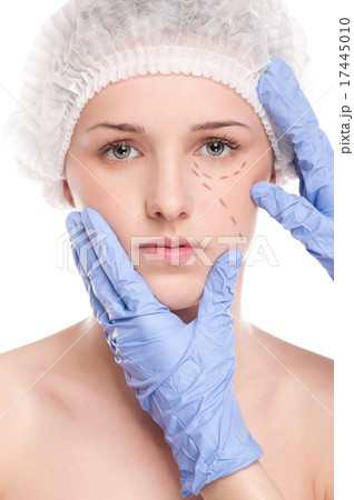 Beautician draw correction lines on woman face 17445010