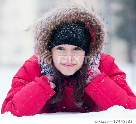 Happy young woman plays with a snow Happy young woman plays with a snow 17445532