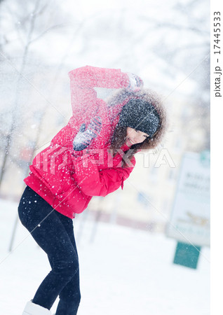 Happy young woman plays with a snow 17445533