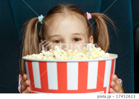 Adorable little girl with popcorn Adorable little girl with popcorn 17452613