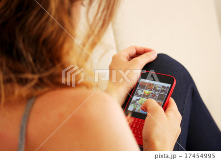Girl is using her red mobile phone 17454995