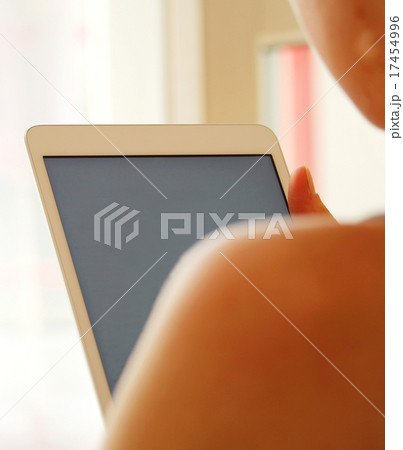 Girl is using her modern white tablet 17454996