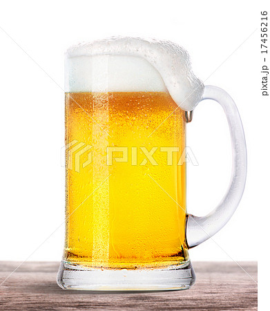 Frosty beer with foam isolated on wooden table 17456216