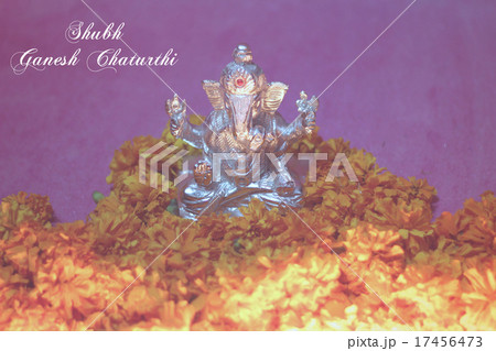 Ganesh idol with sunflower and oil lamp 17456473