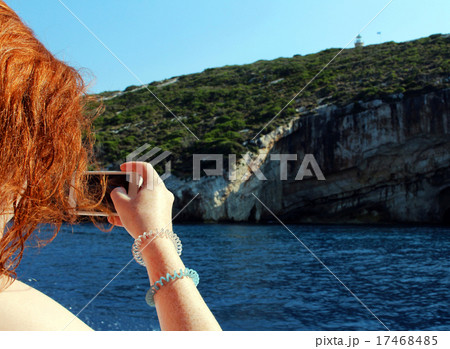 Girl makes photo with mobile phone on the holiday 17468485