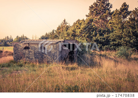 Small brick house on a field 17470838