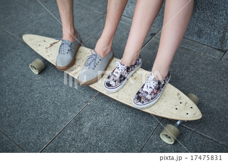 Feet couple of teenagers on the longboard closeup Feet couple of teenagers on the longboard closeup 17475831