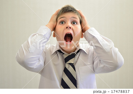 Teen boy screaming holding his hands behind head Teen boy screaming holding his hands behind head 17478837