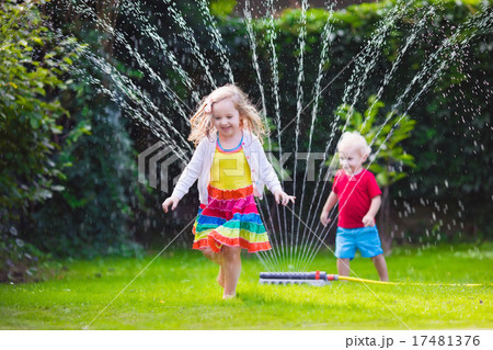 Kids playing with garden sprinkler Kids playing with garden sprinkler 17481376