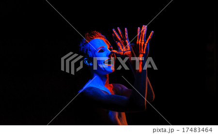 Portrait of a young man covered with neon paint 17483464