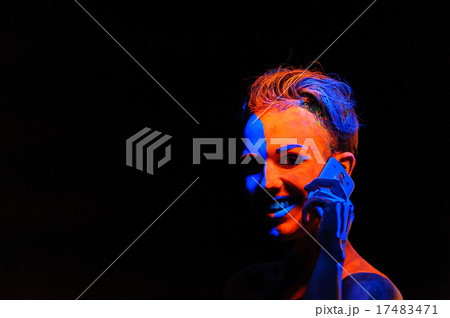 Portrait of a young man covered with neon paint Portrait of a young man covered with neon paint 17483471