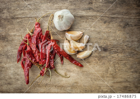 Dried red chili pepper and fresh garlic on wooden Dried red chili pepper and fresh garlic on wooden 17486875