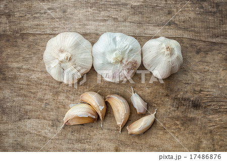 Fresh garlic isolated on wooden background Fresh garlic isolated on wooden background 17486876