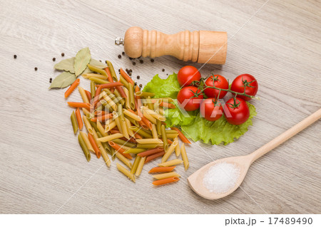 Pasta, tomatoes and pepper on a wooden background 17489490