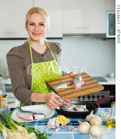 Blond girl with raw fish Blond girl with raw fish 17497011