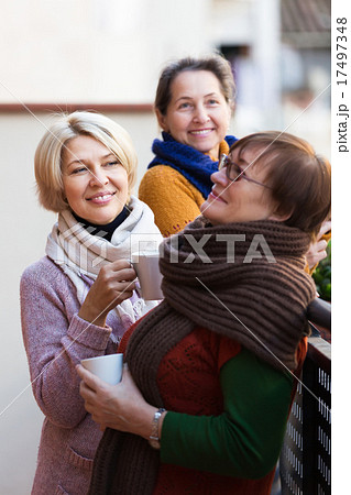 Senior women drinking tea at balcony Senior women drinking tea at balcony 17497348