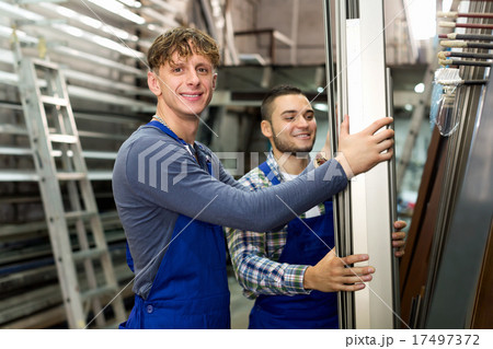 Worker choosing PVC window profile 17497372