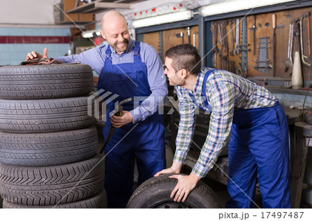 Two car mechanics at workshop Two car mechanics at workshop 17497487