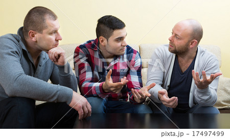 Guys sharing problems at the table Guys sharing problems at the table 17497499