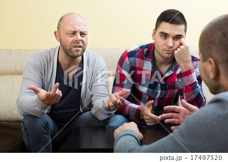 Guys sharing problems at the table Guys sharing problems at the table 17497520