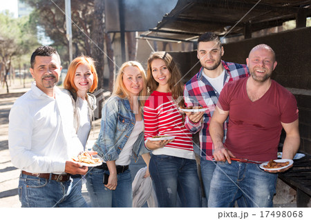 Friends taking pictures together at barbecue Friends taking pictures together at barbecue 17498068