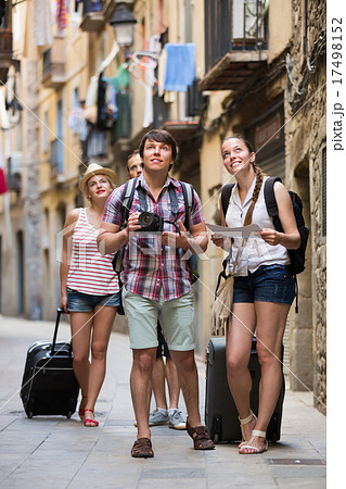 Group of merry tourists with camera and map 17498152