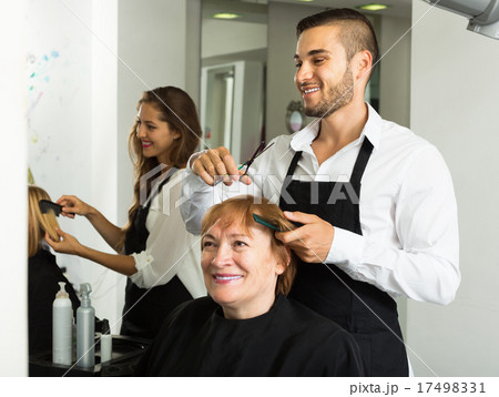 Mature woman cuts hair 17498331