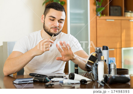 man using nail file man using nail file 17498393