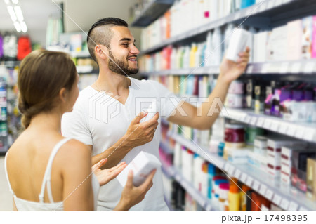 Man buying cosmetical cream in the shopping mall Man buying cosmetical cream in the shopping mall 17498395